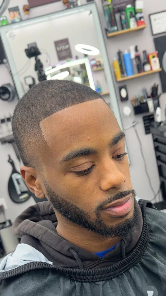 Side profile showing a wave haircut with a smooth low fade from Norie’s Booksy portfolio