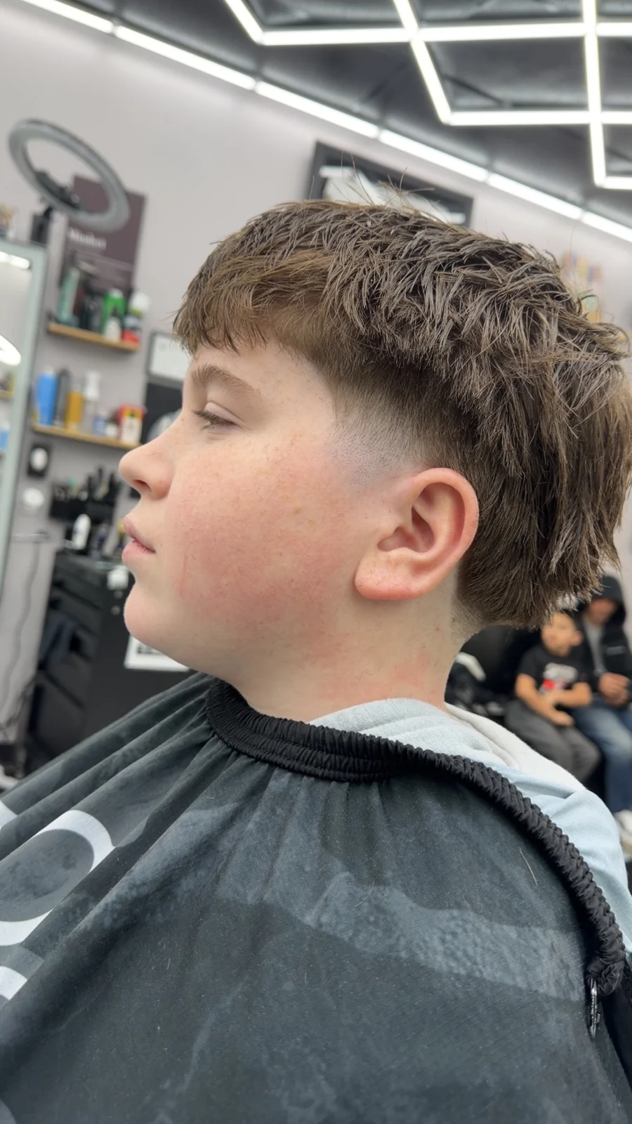 Uncropped side profile showing a textured haircut and taper from Norie’s SQUIRE portfolio